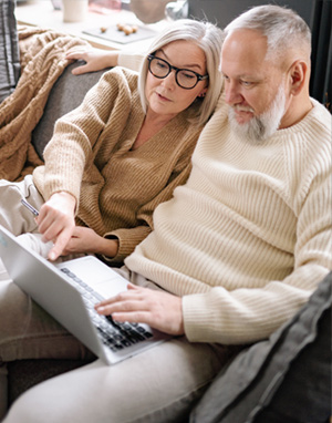 Elderly couple looking at a laptop